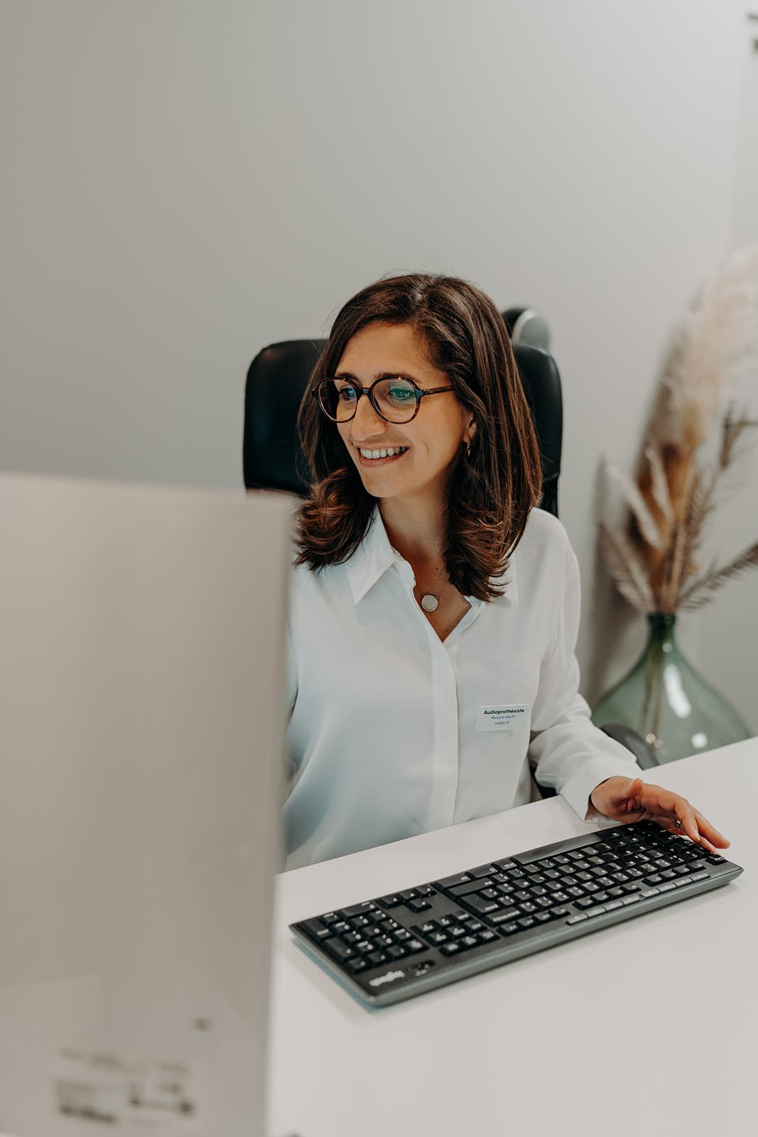 Audioprothésiste réalisant le suivi informatique d’un patient